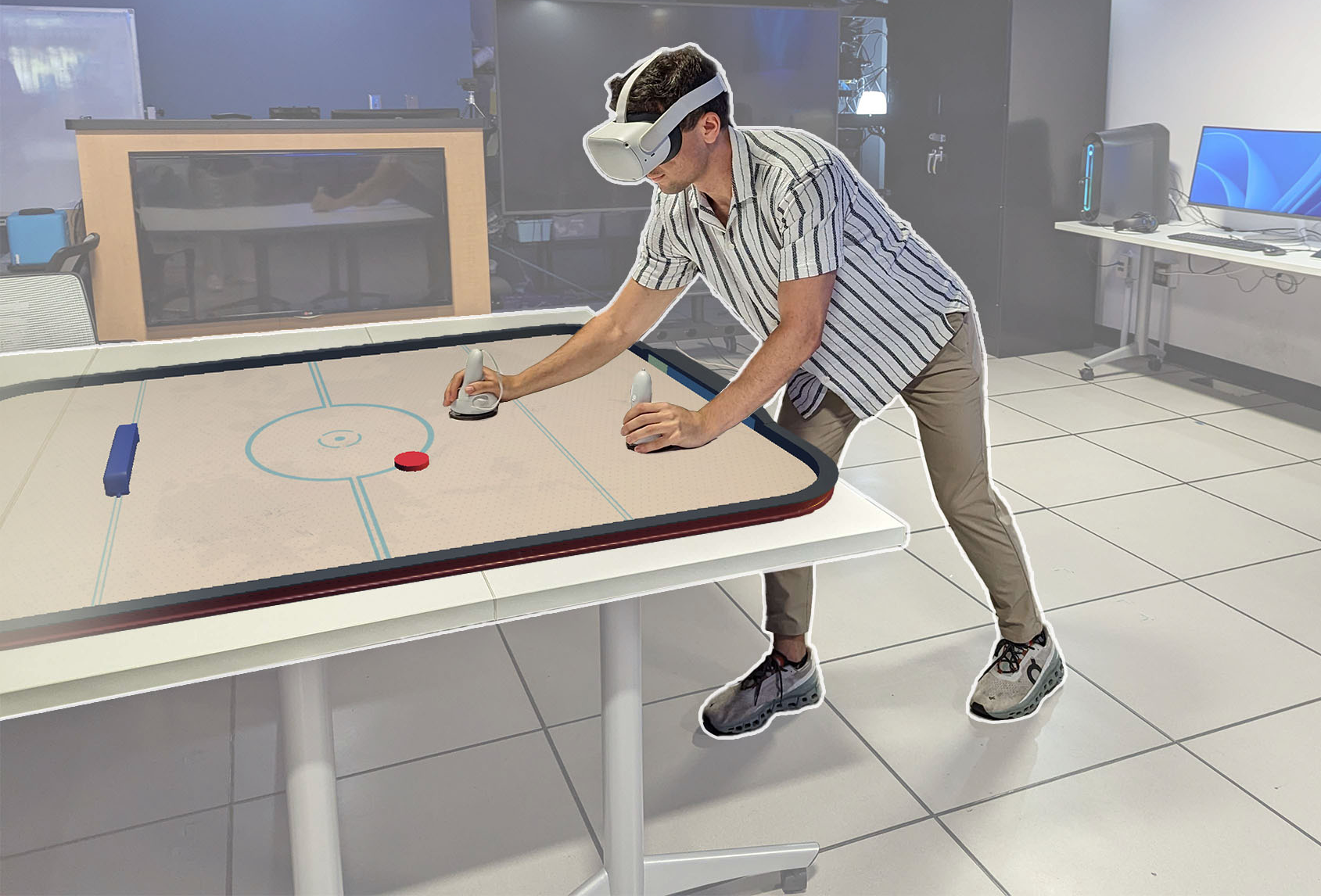 A student testing and immersive and haptic interaction prototype in a research lab.